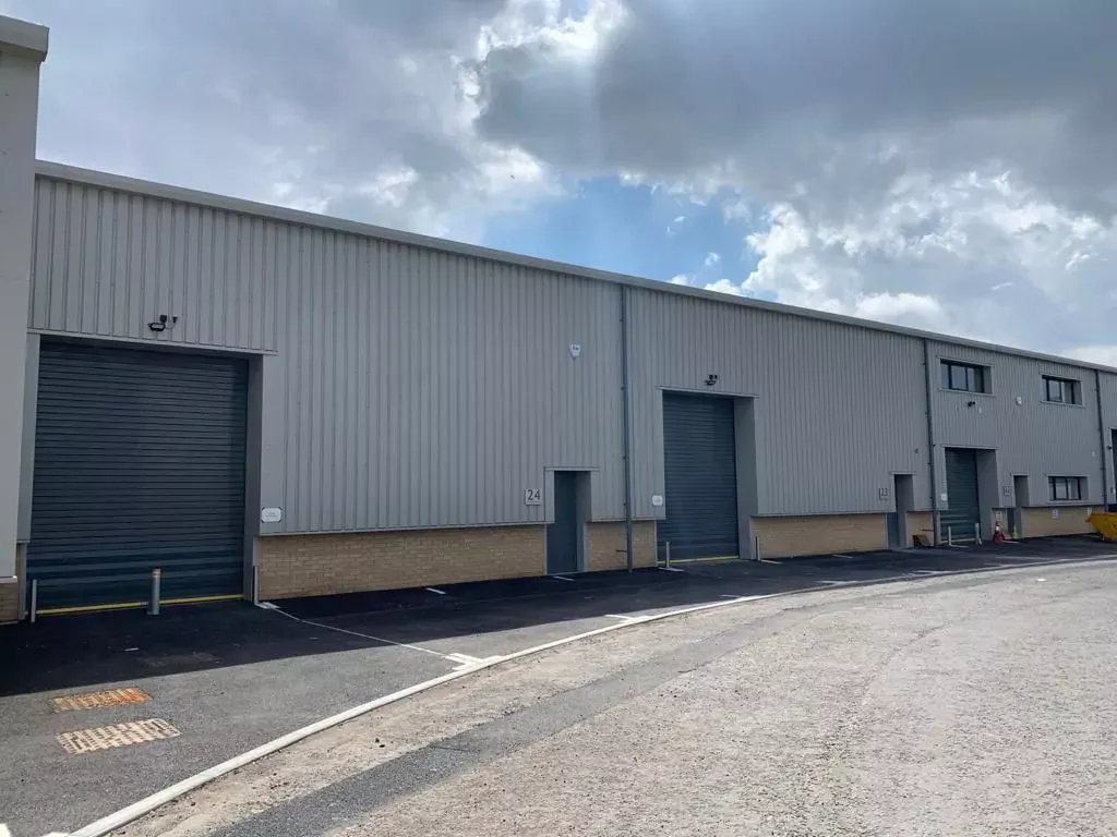 Outside of warehouse, blue roller shutter doors