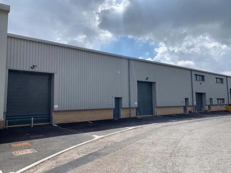 External image of warehouse with insulated roller doors. Warehouse doors guide by B&B Doors.